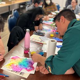 Two individuals pouring over a visual artwork